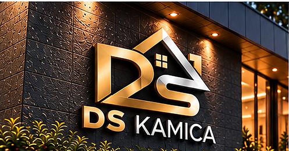 DS Kamica illuminated logo sign on a dark stone building facade